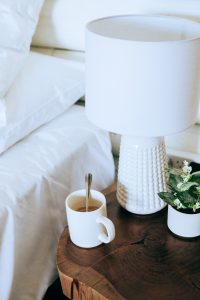 Coffee cup sitting on a bedside table